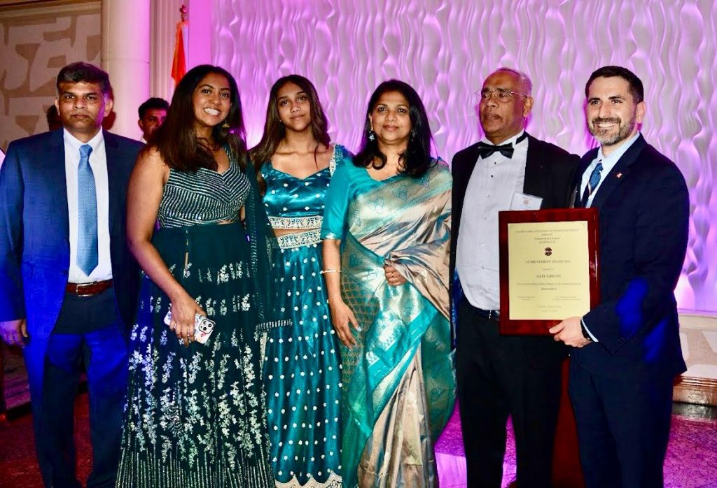 CT Assemblyman Jonathan Jacobson presenting award plaque to veteran journalist Ajay Ghosh