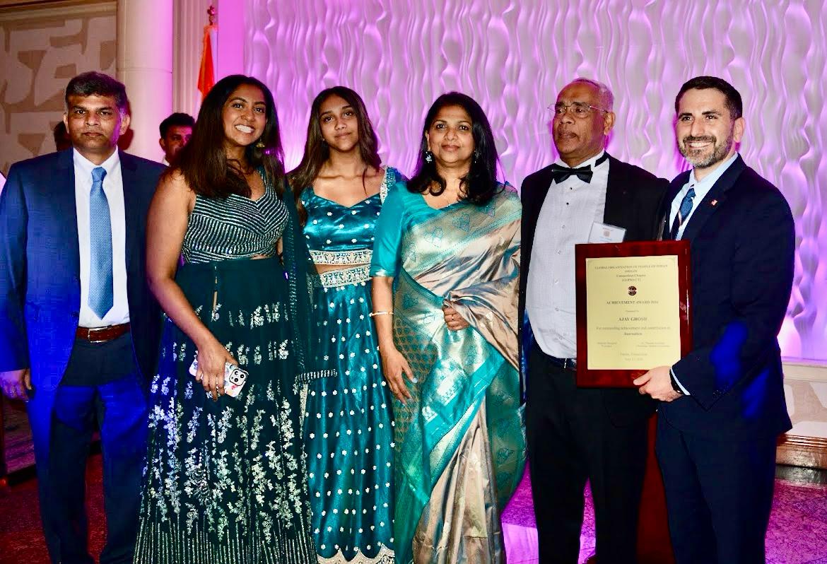 CT Assemblyman Jonathan Jacobson presenting award plaque to veteran journalist Ajay Ghosh